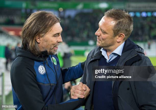Wolfsburg head coach Martin Schmidt and Hannover's director of sports Horst Heldt speaking with each other in the arena ahead of the DFB Cup soccer...