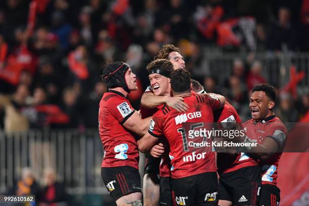 Scott Barrett of the Crusaders is congratulated by team mates after scoring a try during the round 18 Super Rugby match between the Crusaders and the...