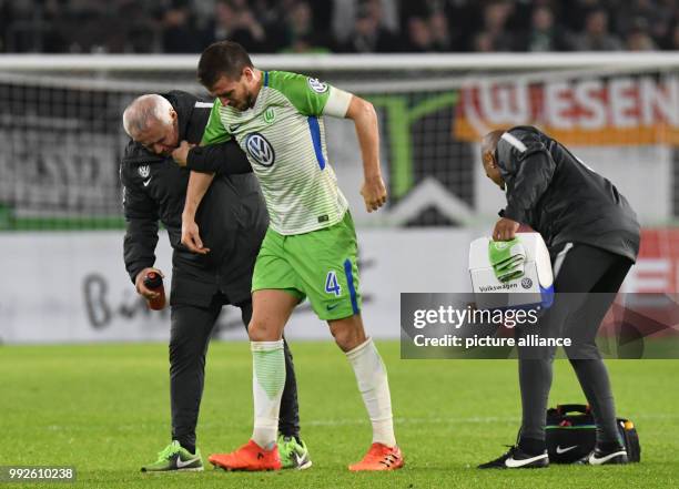 Wolfsburg's Ignacio Camacho leaving injured the field during the DFB Cup soccer match between VfL Wolfsburg and Hannover 96 in the Volkswagen Arena...