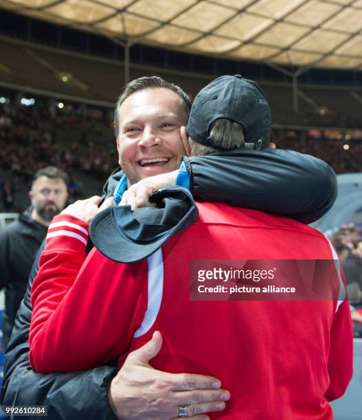 Berlin head coach Pal Dardai greeting and hugging Cologne head coach Peter Stoger ahead of the DFB Cup soccer match between Hertha BSC vs 1. FC...