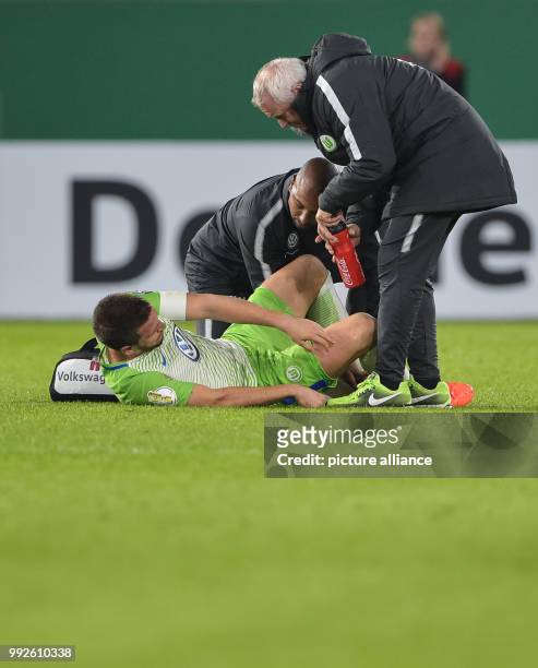 Wolfsburg's Ignacio Camacho lying injured on the pitch during the DFB Cup soccer match between VfL Wolfsburg and Hannover 96 in the Volkswagen Arena...