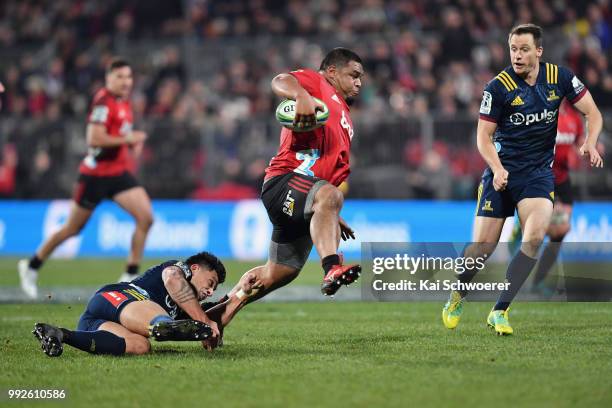 Andrew Makalio of the Crusaders is tackled by Rob Thompson of the Highlanders during the round 18 Super Rugby match between the Crusaders and the...