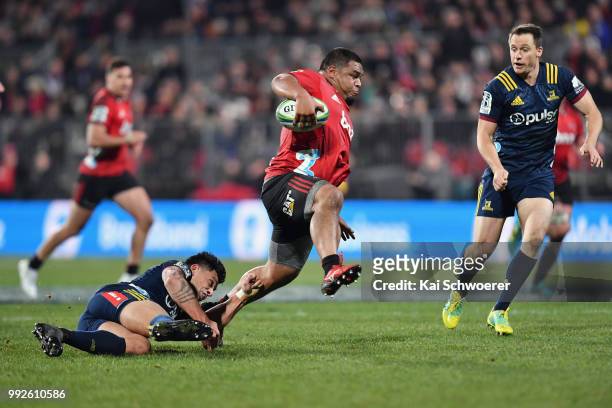 Andrew Makalio of the Crusaders is tackled by Rob Thompson of the Highlanders during the round 18 Super Rugby match between the Crusaders and the...