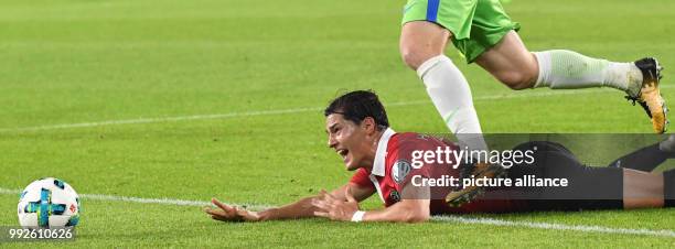 Wolfsburg's Jakub Blaszczykowski and Hannover's Miiko Albornoz vying for the ball during the DFB Cup soccer match between VfL Wolfsburg and Hannover...