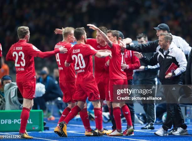 Cologne's Simon Zoller celebrates with teammates after scoring his side's opening goal during the German DFB Pokal football match between Hertha BSC...