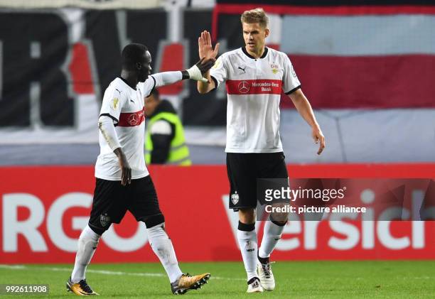 Stuttgart scorer Simon Terodde celebrating with Chadrac Akolo after scoring the 1:3 during the DFB Cup soccer match between 1. FC Kaiserslautern and...