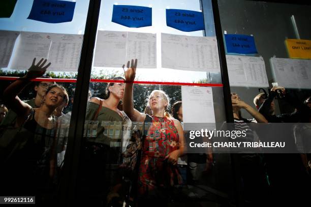 Students react as they check the results of the French general baccalaureat exam at the lycee Malherbe in Caen, northwestern France, on July 6, 2018.