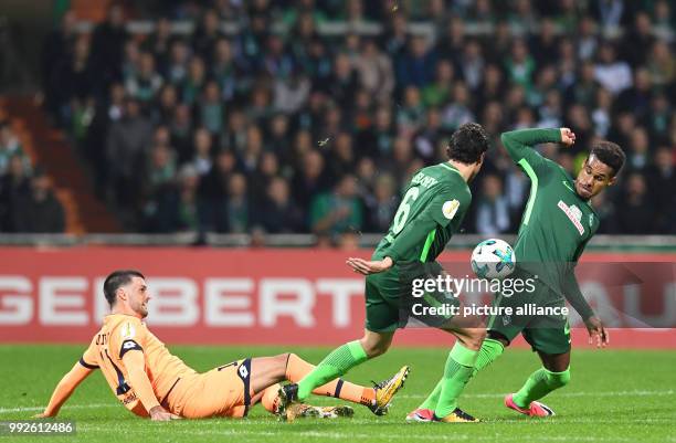 Bremen's Thomas Delaney and Theodor Gebre Selassie vying for the ball against Hoffenheim's Florian Grillitsch during the DFB Cup soccer match between...