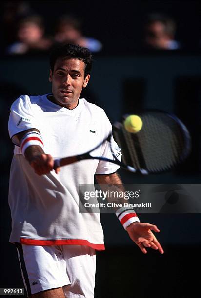 Alex Corretja of Spain returns in his fourth round match winning against Fabrice Santoro of France 6/2 6/3 6/4 during the French Open Tennis at...