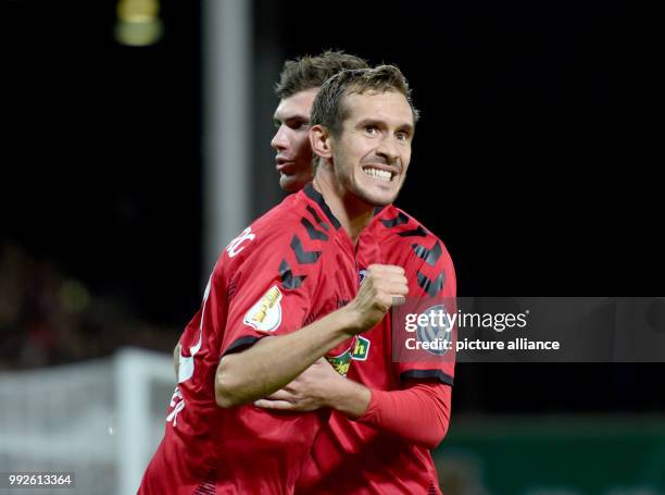 Freiburg's Julian Schuster and Pascal Stenzel. Celebrate a goal during the DFB Cup soccer match between SC Freiburg and Dynamo Dresden in Freiburg,...