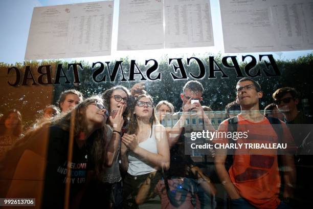 Students check the results of the French general baccalaureat exam at the lycee Malherbe in Caen, northwestern France, on July 6, 2018.