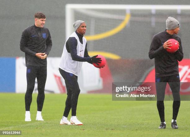 John Stones, Ashley Young and Trent Alexander-Arnold take part in a drill during an England training session at Spartak Zelenogorsk Stadium on July...