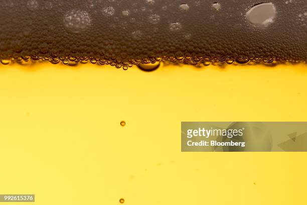 Bubbles, produced by carbon dioxide, float to the top of a glass of lager in this arranged photograph in London, U.K., on Thursday, July 5, 2018....