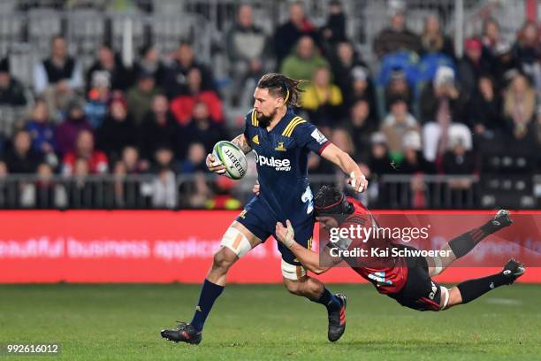 Elliot Dixon of the Highlanders is tackled by Matt Todd of the Crusaders during the round 18 Super Rugby match between the Crusaders and the...