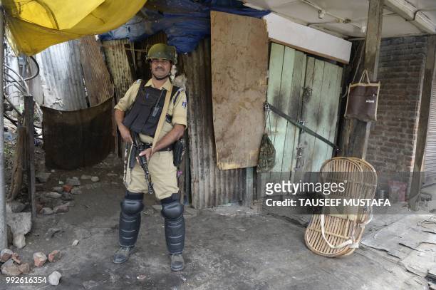 An Indian paramilitary trooper stands guard outside the Jamia Masjid mosque after authorities imposed restrictions in downtown Srinagar on July 6,...