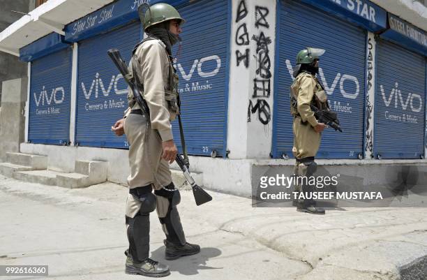 Indian paramilitary troopers stand guard outside the Jamia Masjid mosque during restrictions in downtown Srinagar on July 6, 2018. - Indian...
