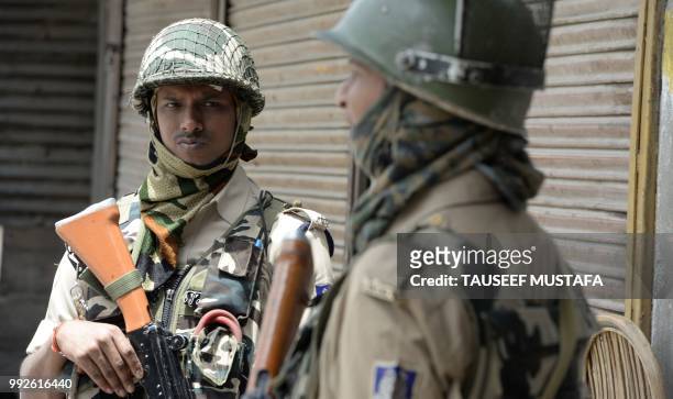 Indian paramilitary troopers stand guard outside the Jamia Masjid mosque after authorities imposed restrictions in downtown Srinagar on July 6, 2018....