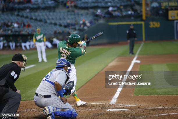 Khris Davis of the Oakland Athletics hits his second home run of the night during the game against the Kansas City Royals at the Oakland Alameda...