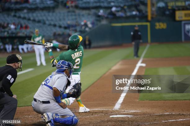 Khris Davis of the Oakland Athletics hits his second home run of the night during the game against the Kansas City Royals at the Oakland Alameda...