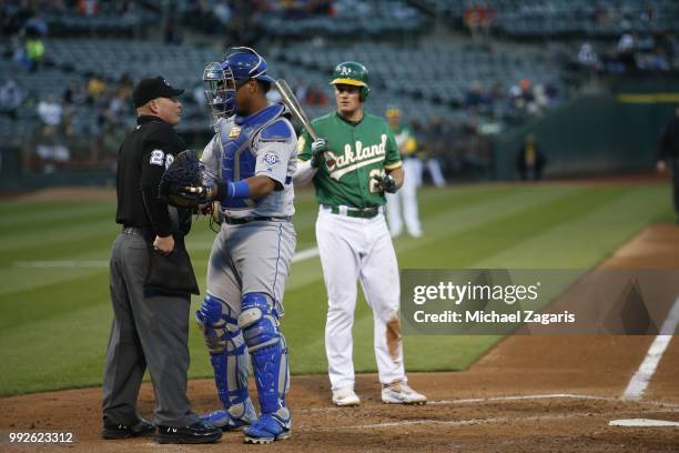 Salvador Perez of the Kansas City Royals stands on the field after taking a foul ball off his mask during the game against the Oakland Athletics at...