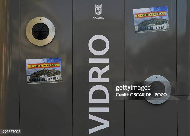 Sticker reading 'Do not touch The Valley' and depecting a picture of Valle de los Caidos are pictured in a street of Madrid on July 02, 2018. -...