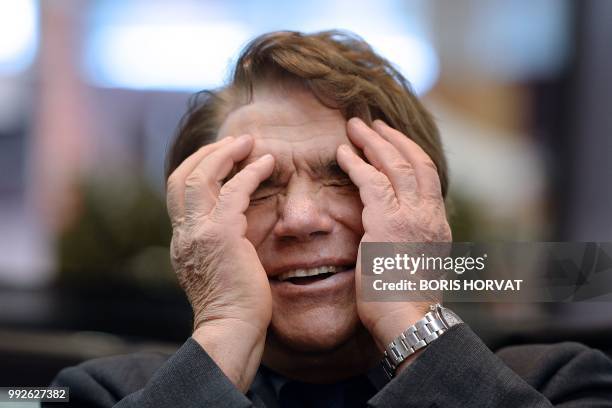 French businessman Bernard Tapie, owner of the French newspaper La Provence, reacts as he attends the inauguration of an auto show in Marseille,...