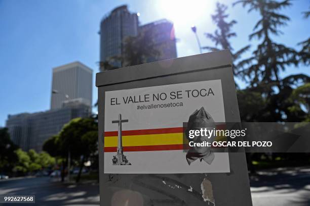 Sticker reading 'Do not touch The Valley' and depecting a portrait of General Francisco Franco is pictured in a street of Madrid on July 02, 2018. -...