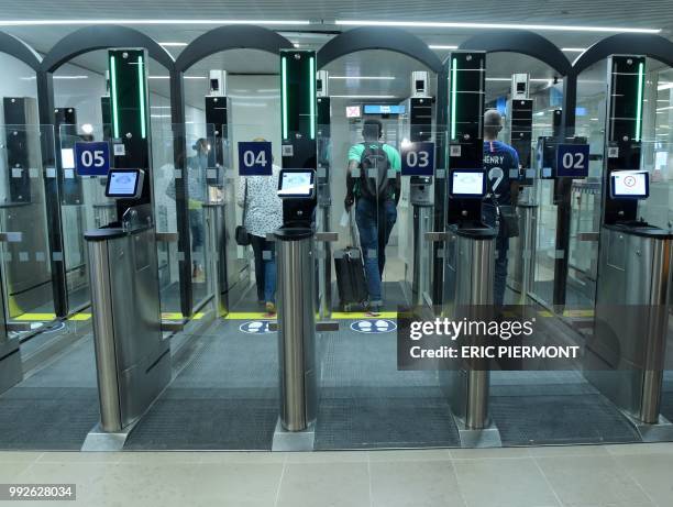 Passengers use "Parafe", an automated border passport control at Orly airport, near Paris on July 6, 2018.