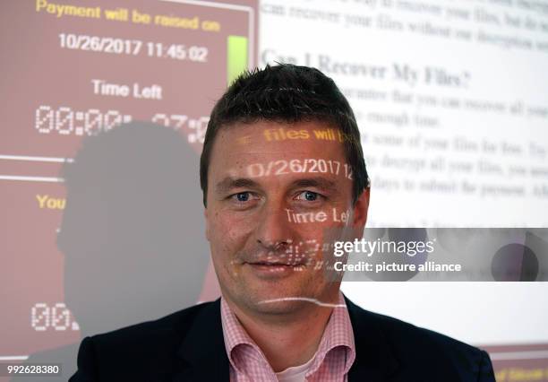 The director of the Cyber Security divison at the Frauenhofer Institute FKIE, Michael Meier, standing in front of a projection in Bonn, Germany, 26...