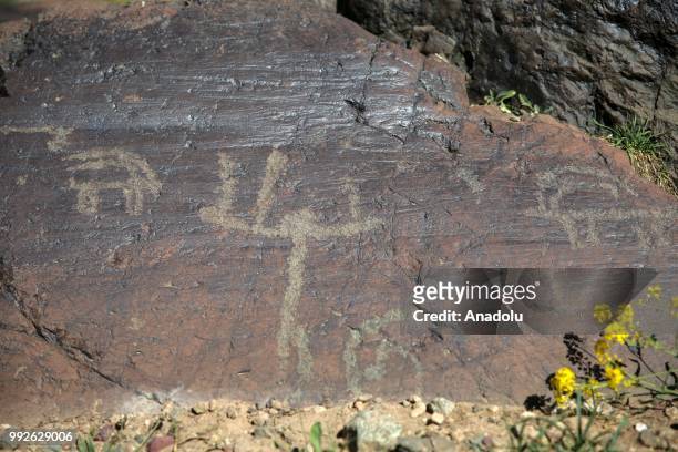 Petroglyphs, depicting animals, humans along with other symbols are seen on a rock found close to the summit of Mount Cilo in Yuksekova district of...