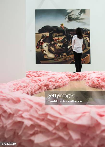 Woman looking at the wallpaper "Autumnal Cannibalism, 1936" by Salvador Dali at the exhibition "Never Ending Stories. Loops in art, film,...