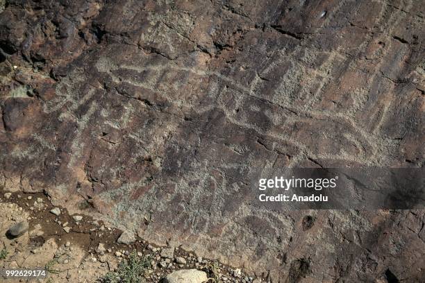 Petroglyphs, depicting animals, humans along with other symbols are seen on a rock found close to the summit of Mount Cilo in Yuksekova district of...