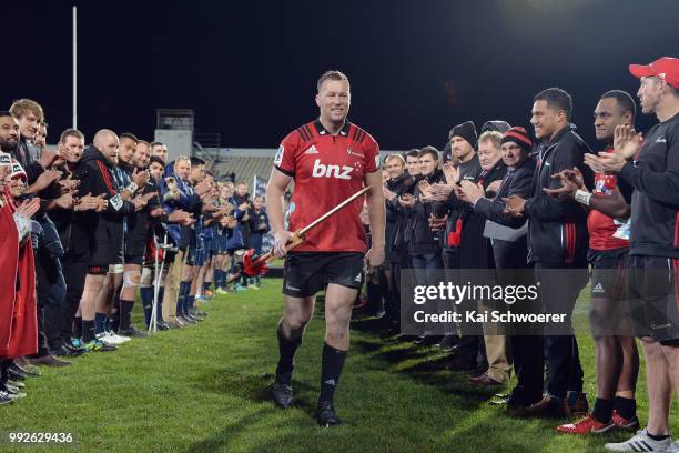 Wyatt Crockett of the Crusaders is congratulated after his 200th Super Rugby match during the round 18 Super Rugby match between the Crusaders and...