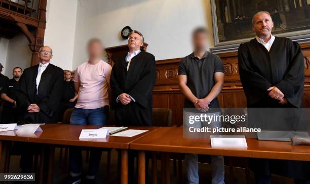 July 2018, Germany, Flensburg: The two defendants indicted for murder standing in the dock with their lawyers Thomas Bliwier , Martin Unger and...