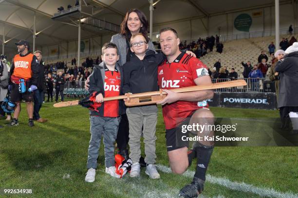 Wyatt Crockett of the Crusaders poses with his wife Jenna and his sons Sonny and Emmett and a taiaha, a traditional Maori weapon, after his 200th...