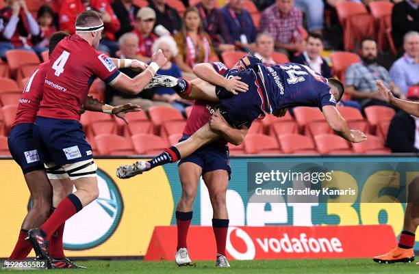 Jack Maddocks of the Rebels is picked up in the tackly by Hamish Stewart of the Reds during the round 18 Super Rugby match between the Reds and the...