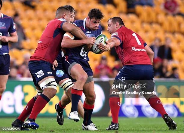 Tom English of the Rebels takes on the defence during the round 18 Super Rugby match between the Reds and the Rebels at Suncorp Stadium on July 6,...