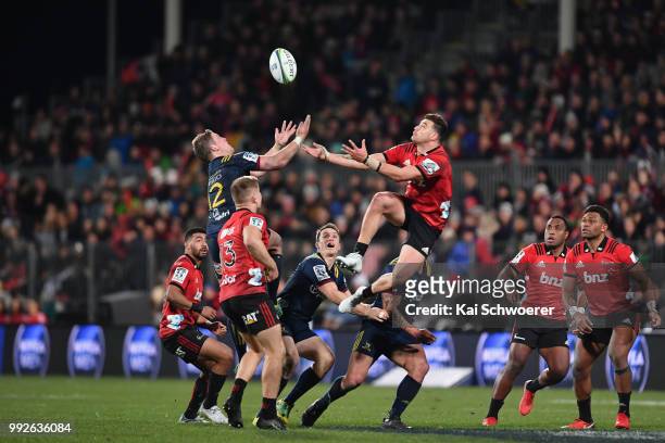 Teihorangi Walden of the Highlanders and David Havili of the Crusaders compete for the ball during the round 18 Super Rugby match between the...