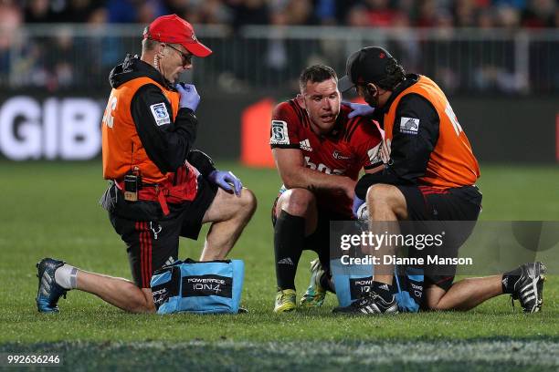 Ryan Crotty of the Crusaders receives attention for an injury during the round 18 Super Rugby match between the Crusaders and the Highlanders at AMI...