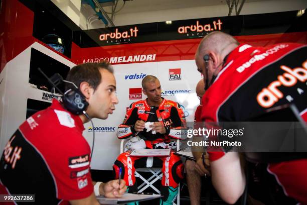 Marco Melandri of Aruba.it Racing - Ducati speaks in box with mechanics during the free practice of the Motul FIM Superbike Championship, Riviera di...