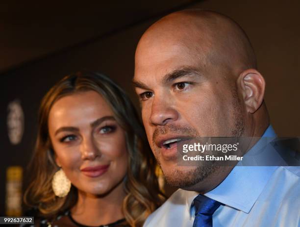 Model Amber Nichole Miller looks on as mixed martial artist Tito Ortiz is interviewed at the UFC Hall of Fame's class of 2018 induction ceremony at...