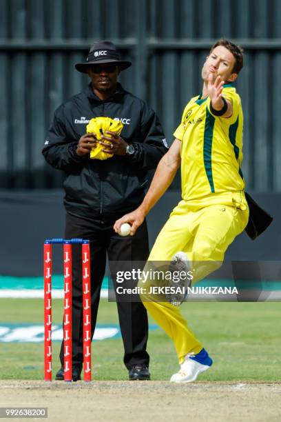 Australia's bowler Andrew Tye delivers the ball past umpire Jeremiah Matibiri during the sixth T20 cricket match between Australia and host nation...