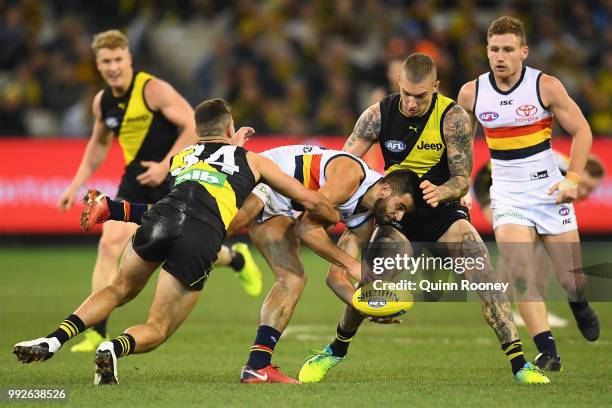 Wayne Milera of the Crows is tackled by Jack Graham of the Tigers during the round 16 AFL match between the Richmond Tigers and the Adelaide Crows at...