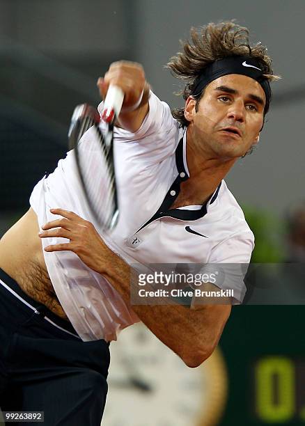 Roger Federer of Switzerland serves against Stanislas Wawrinka of Switzerland in their third round match during the Mutua Madrilena Madrid Open...