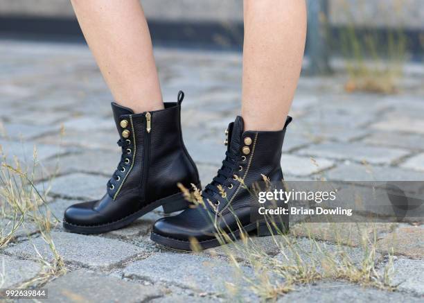 Kathrin Gelinsky, shoe detail, poses during the Marc Cain Street Style shooting at WECC on July 3, 2018 in Berlin, Germany.