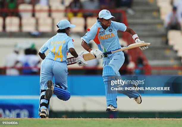 Indian cricketers Harmanpreet Kaur and Poonam Raul take a run during the ICC Women�s World Cup Twenty20 semi final match between Australia and India...
