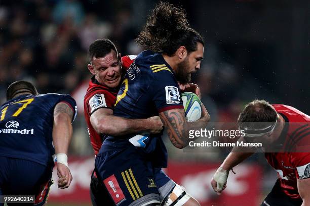 Jackson Hemopo of the Highlanders is tackled by Ryan Crotty of the Crusaders during the round 18 Super Rugby match between the Crusaders and the...