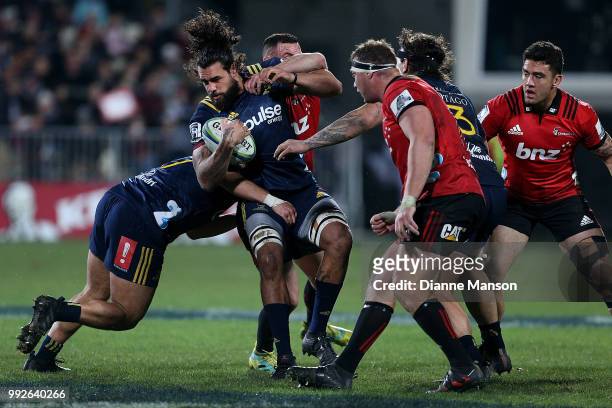 Jackson Hemopo of the Highlanders is tackled by Ryan Crotty of the Crusaders during the round 18 Super Rugby match between the Crusaders and the...