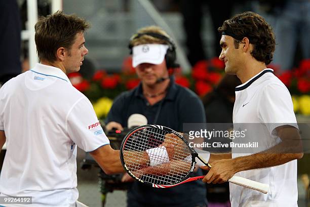 Roger Federer of Switzerland shakes hands at the net after his straight sets victory against Stanislas Wawrinka of Switzerland in their third round...