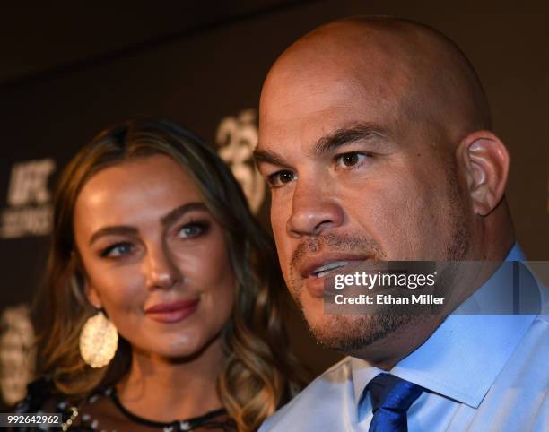 Model Amber Nichole Miller looks on as mixed martial artist Tito Ortiz is interviewed at the UFC Hall of Fame's class of 2018 induction ceremony at...